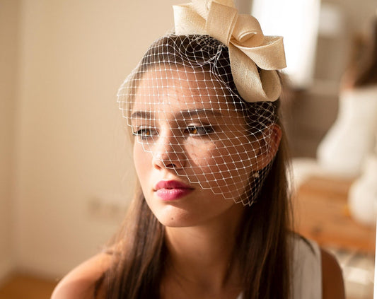 Bridal bow fascinator with birdcage veil