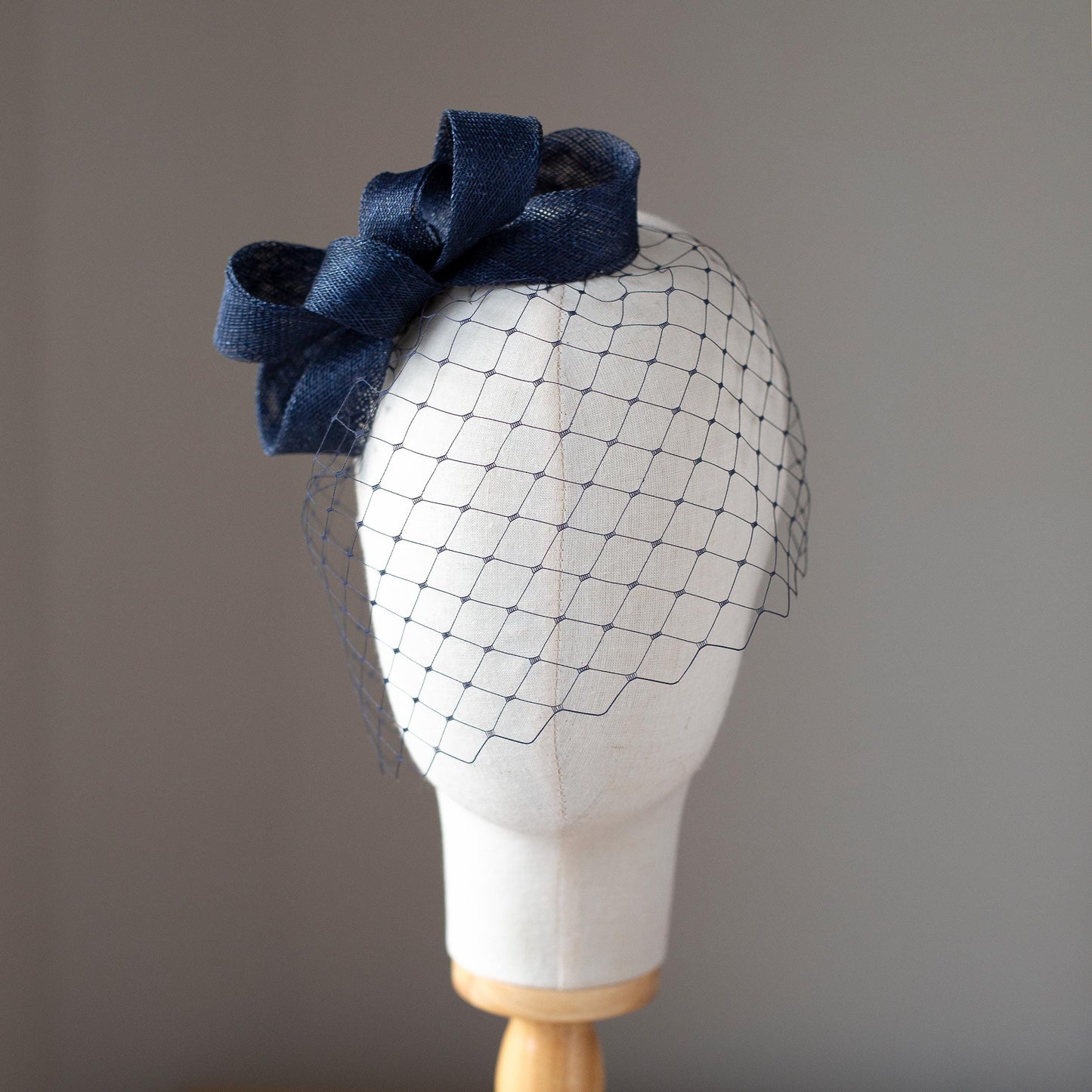 Formal headpiece bow with navy birdcage modern navy veil and minimalist fascinator wedding guest hair accessory in custom colours